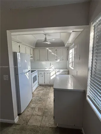a kitchen with stainless steel appliances granite countertop a sink a refrigerator and a stove