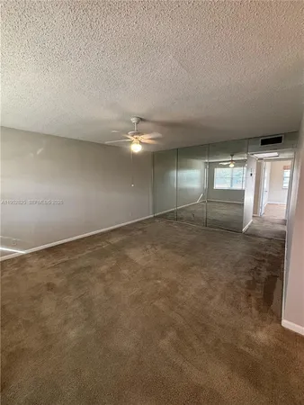a view of a hallway to a livingroom and a livingroom with furniture