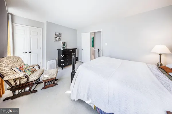 a bedroom with a bed and a couch