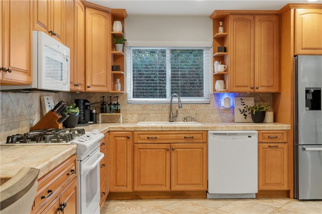 911 Diamond Road Placentia, CA 92870 - Photo 13 of 31 a kitchen with a sink stove and cabinets