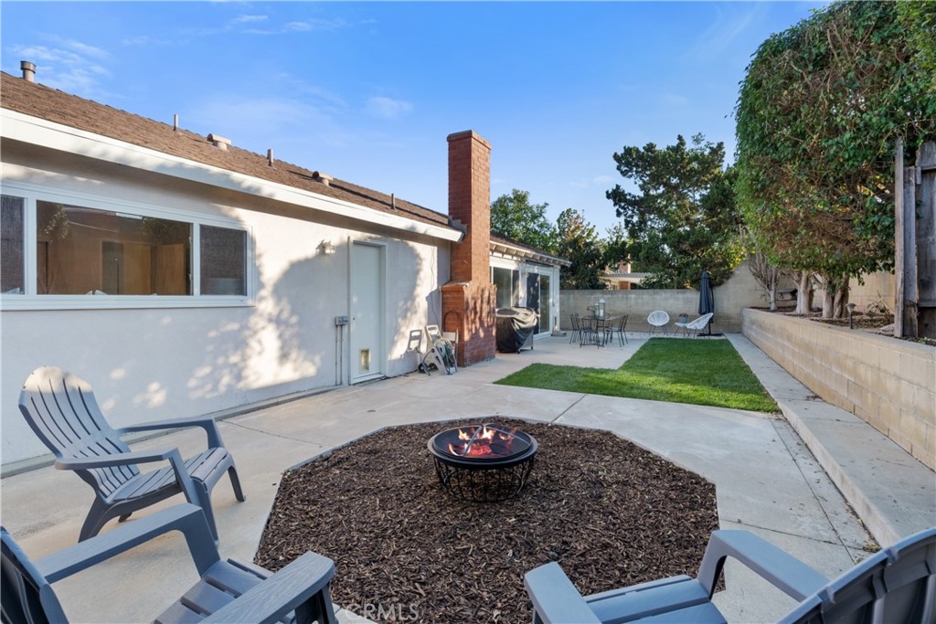 911 Diamond Road Placentia, CA 92870 - Photo 23 of 31 a view of a patio with table and chairs potted plants with wooden floor and fence