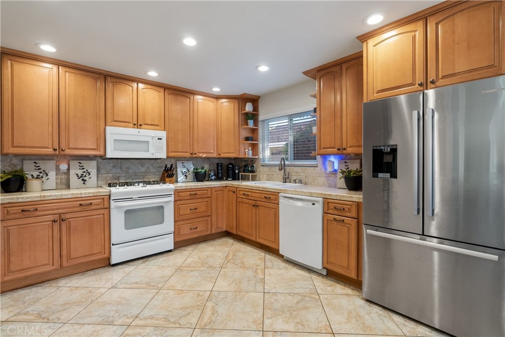 911 Diamond Road Placentia, CA 92870 - Photo 10 of 31 a kitchen with a refrigerator a sink and cabinets