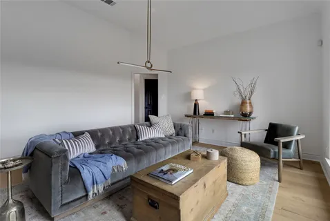 a living room with furniture and a chandelier