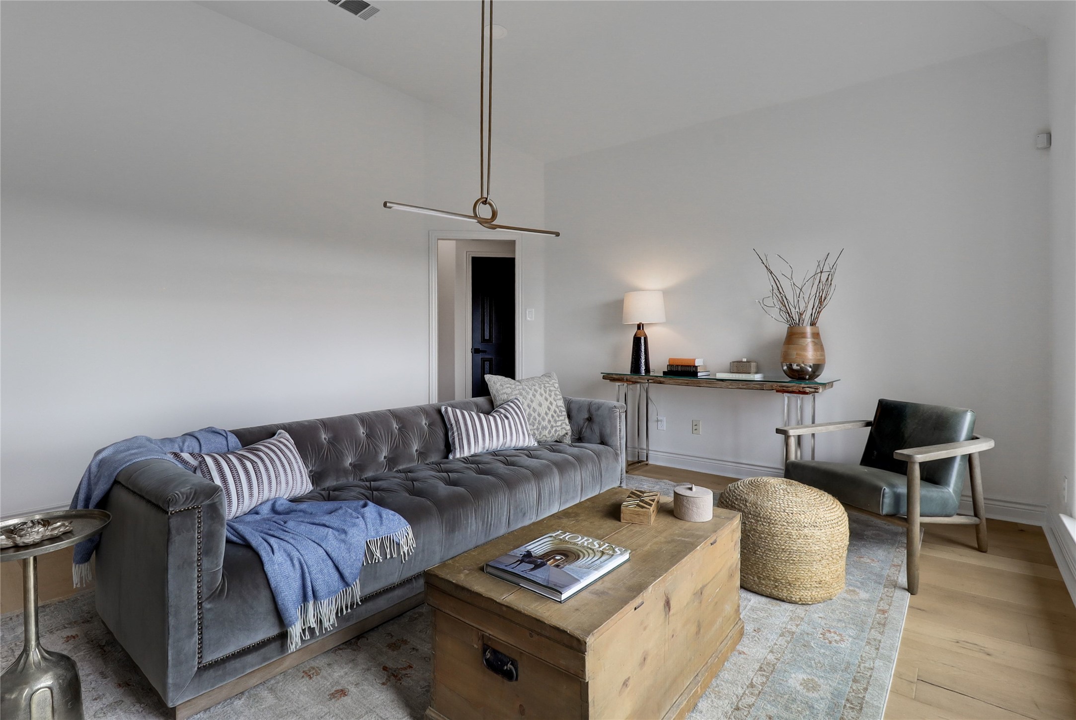 1100 Norwood Road Dripping Springs, TX 78620 - Photo 11 of 38 a living room with furniture and a chandelier