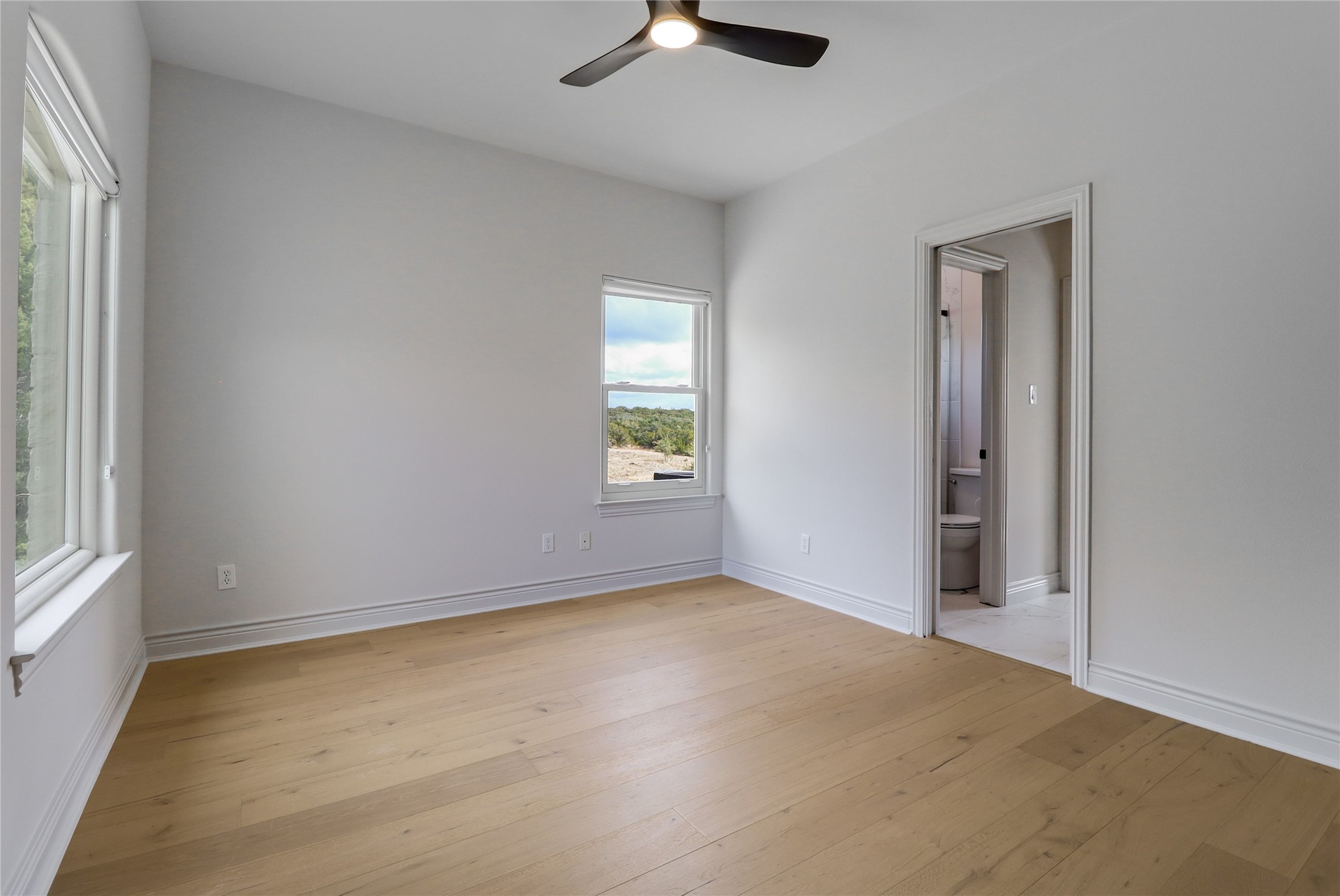 1100 Norwood Road Dripping Springs, TX 78620 - Photo 21 of 38 an empty room with windows and fan