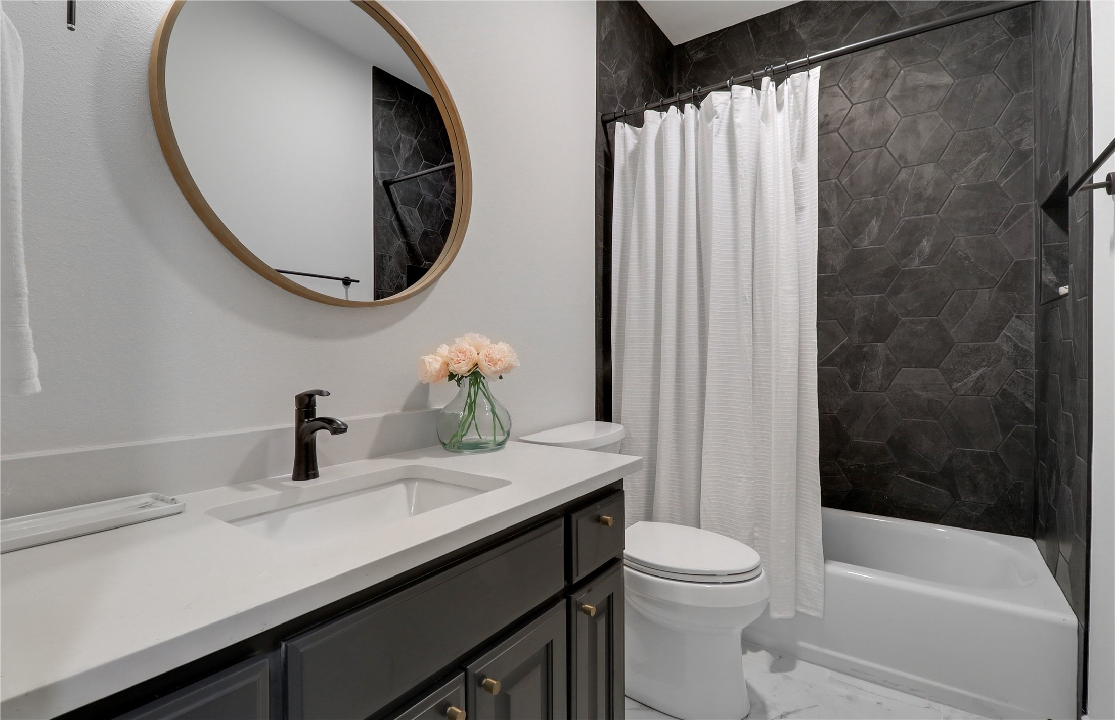 1100 Norwood Road Dripping Springs, TX 78620 - Photo 24 of 38 a bathroom with a sink a toilet and a mirror