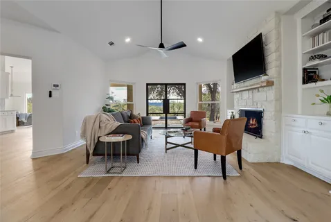 a living room with fireplace furniture and a flat screen tv