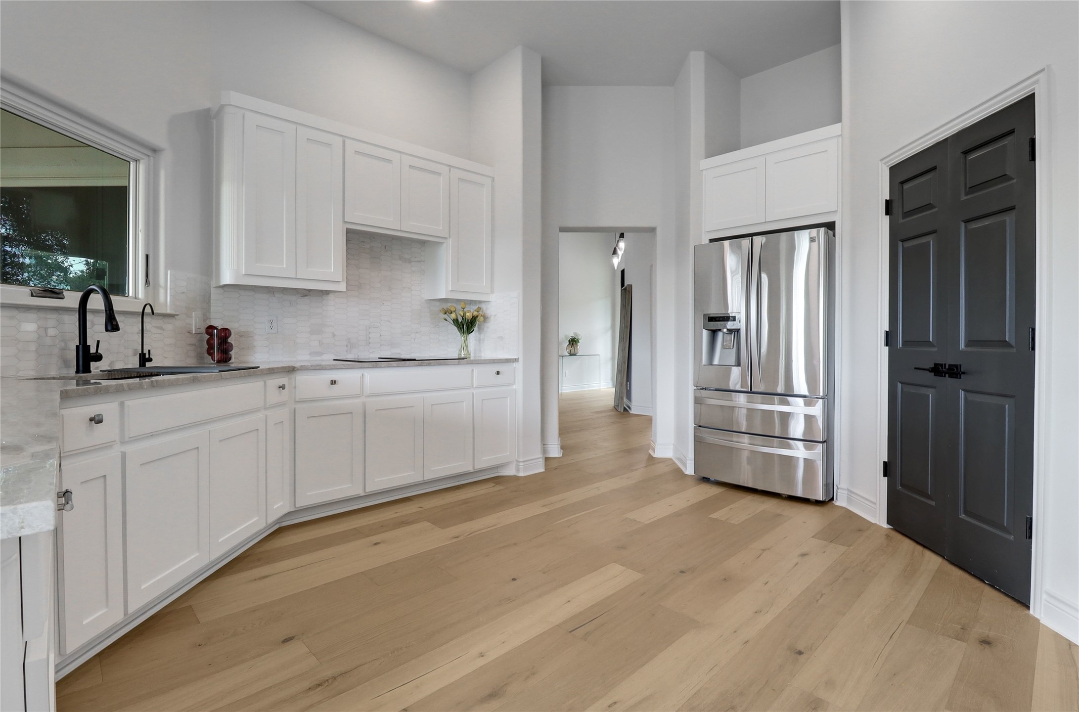 1100 Norwood Road Dripping Springs, TX 78620 - Photo 6 of 38 a kitchen with white cabinets and sink