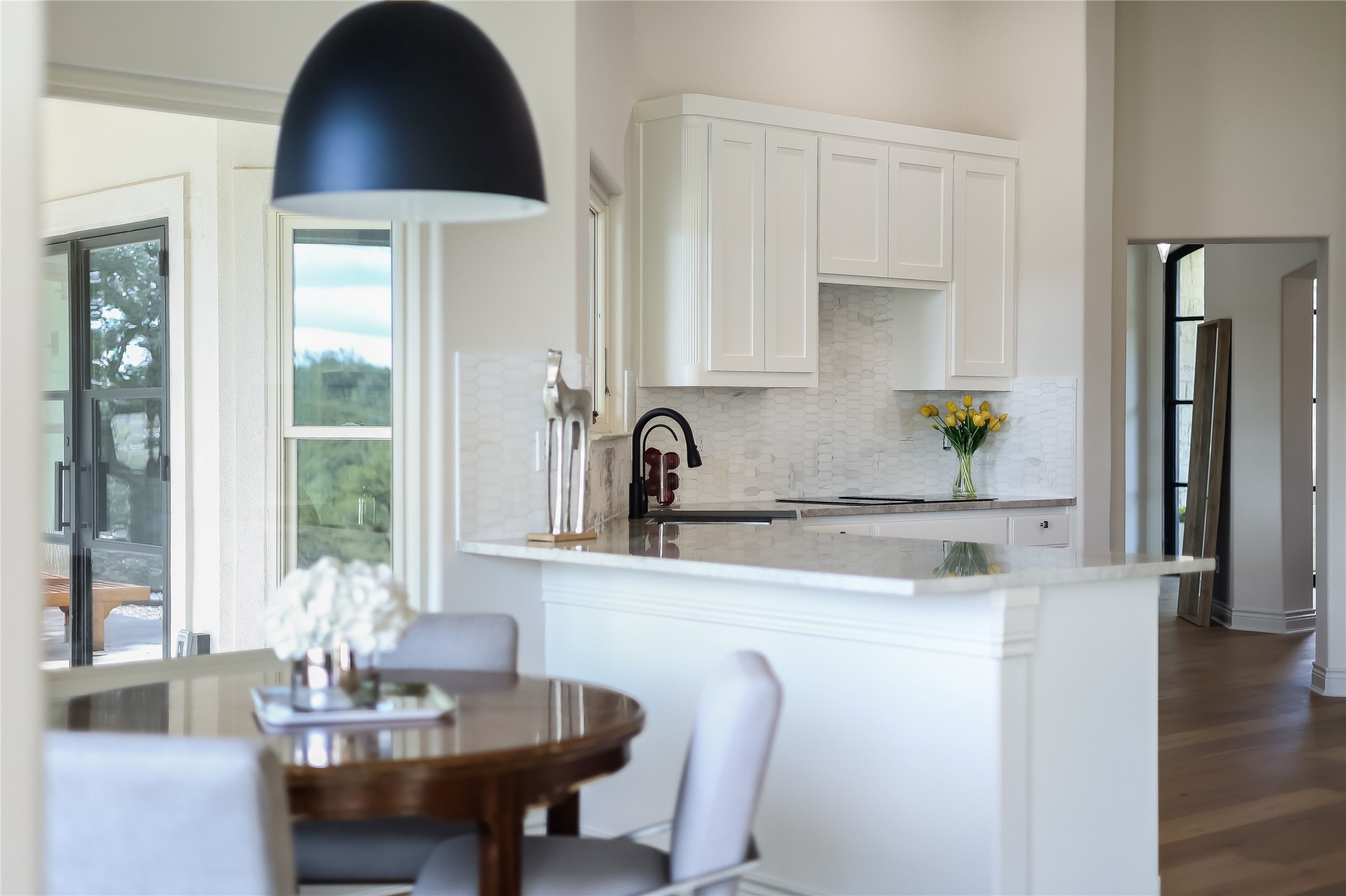1100 Norwood Road Dripping Springs, TX 78620 - Photo 7 of 38 a kitchen with a table and chairs in it