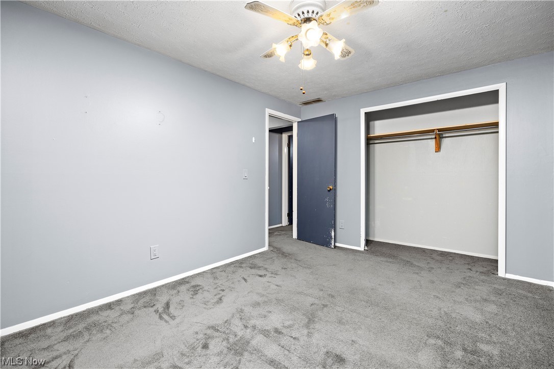 18042 Howe Road Strongsville, OH 44136 - Photo 23 of 35 Unfurnished bedroom with a closet, carpet, and ceiling fan