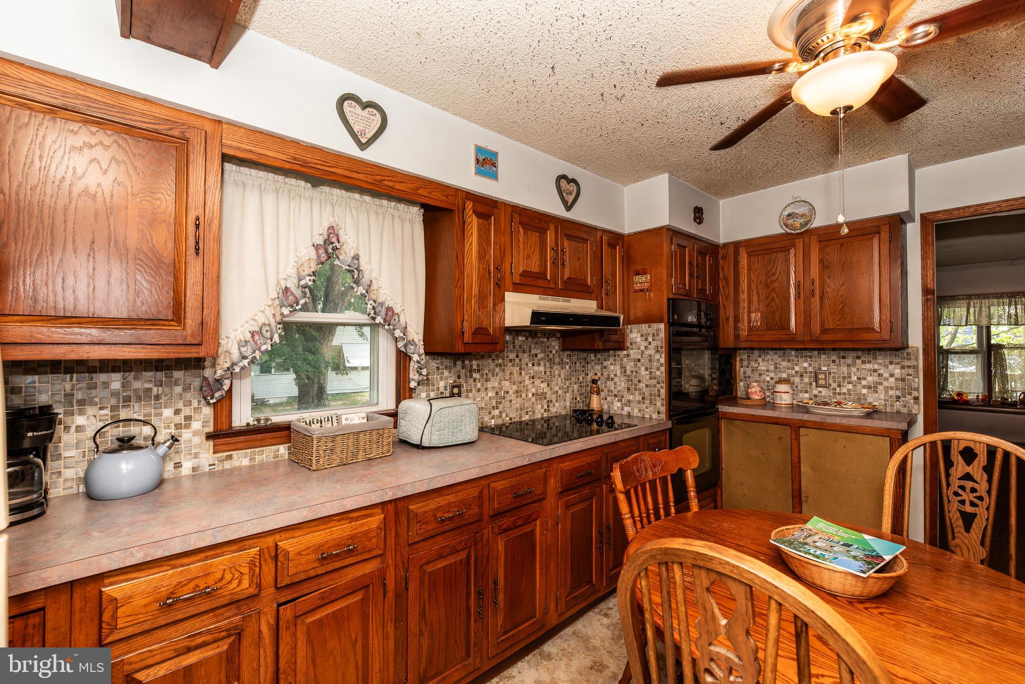 9516 Highland Street Mauricetown, NJ 08329 - Photo 20 of 53 a kitchen with stainless steel appliances kitchen island granite countertop a sink dishwasher and cabinets with wooden floor