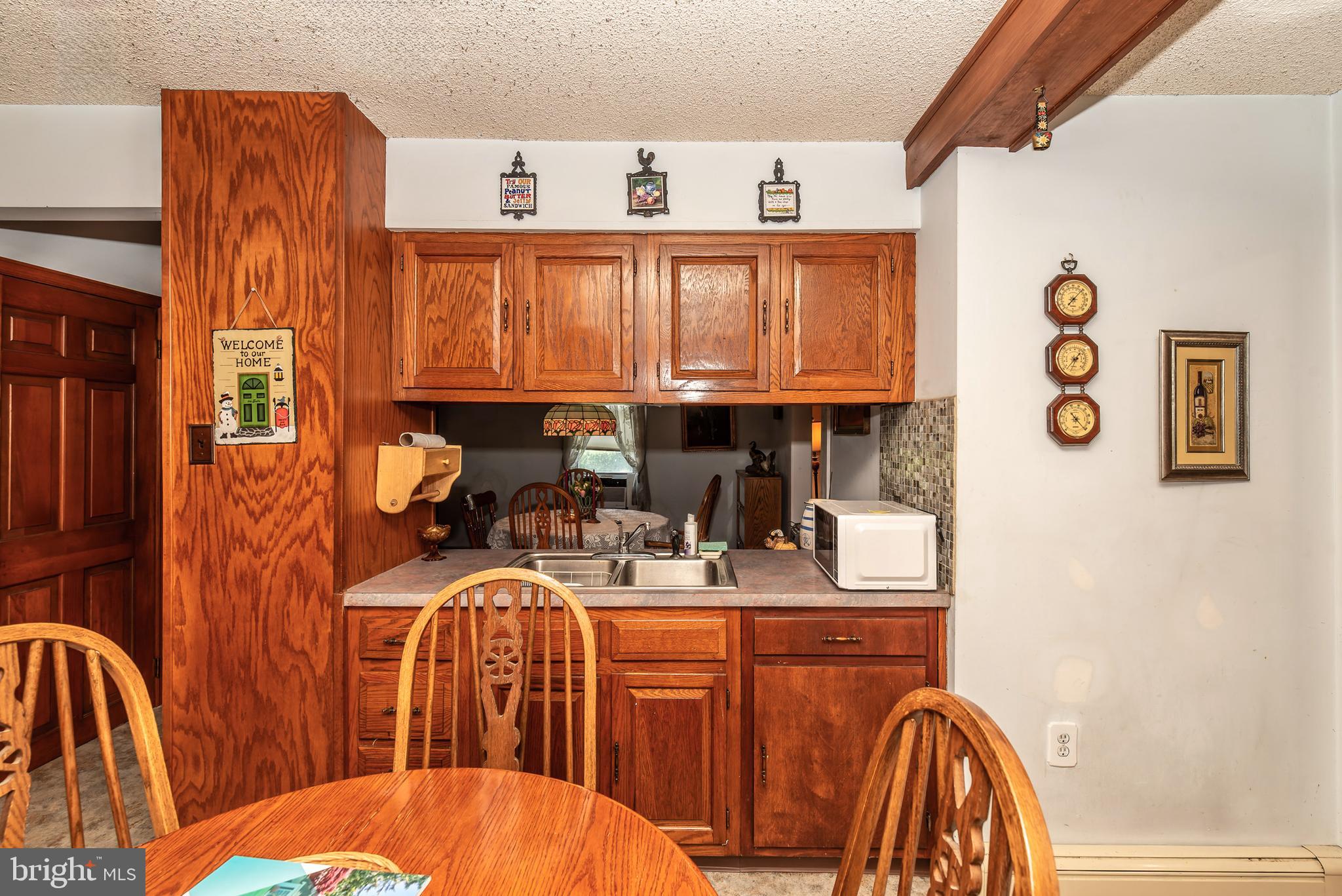 9516 Highland Street Mauricetown, NJ 08329 - Photo 22 of 53 a dining room with furniture a window and a kitchen view