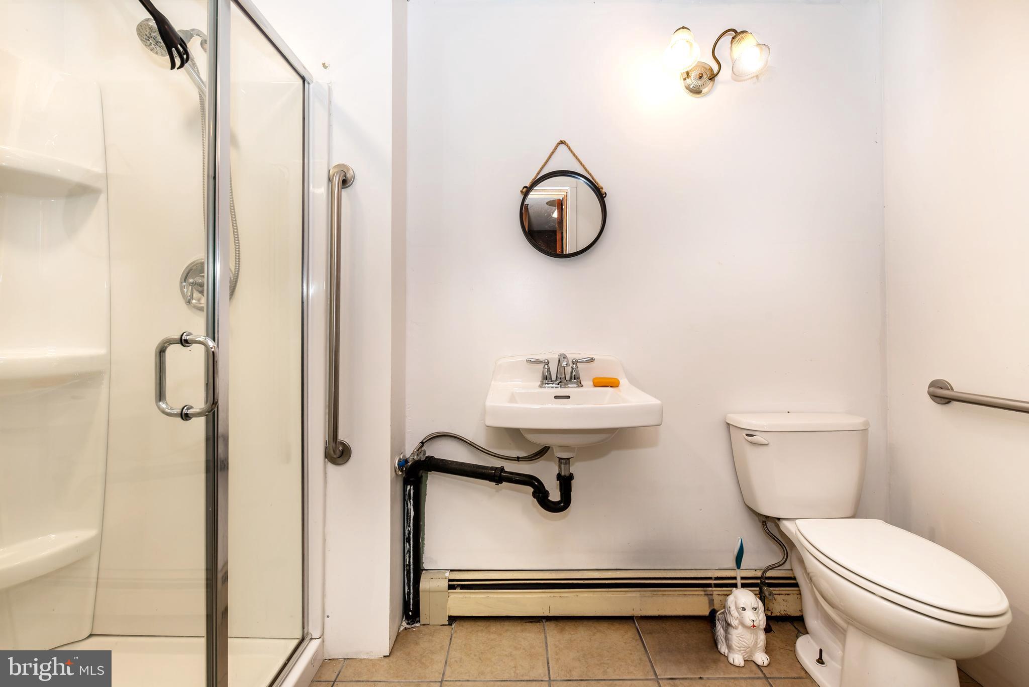 9516 Highland Street Mauricetown, NJ 08329 - Photo 23 of 53 a bathroom with a toilet sink and mirror