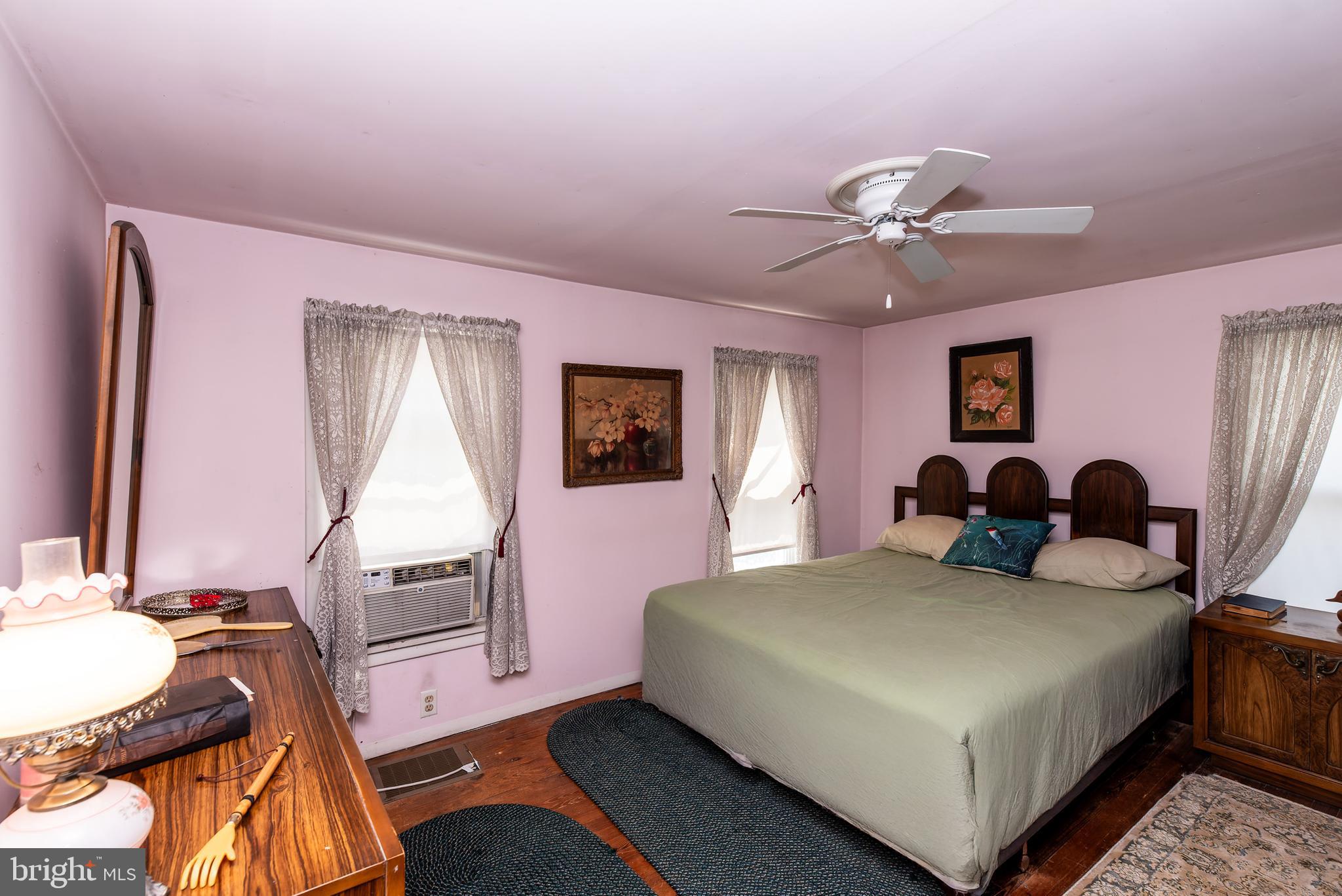 9516 Highland Street Mauricetown, NJ 08329 - Photo 31 of 53 a bedroom with a bed and wooden floor