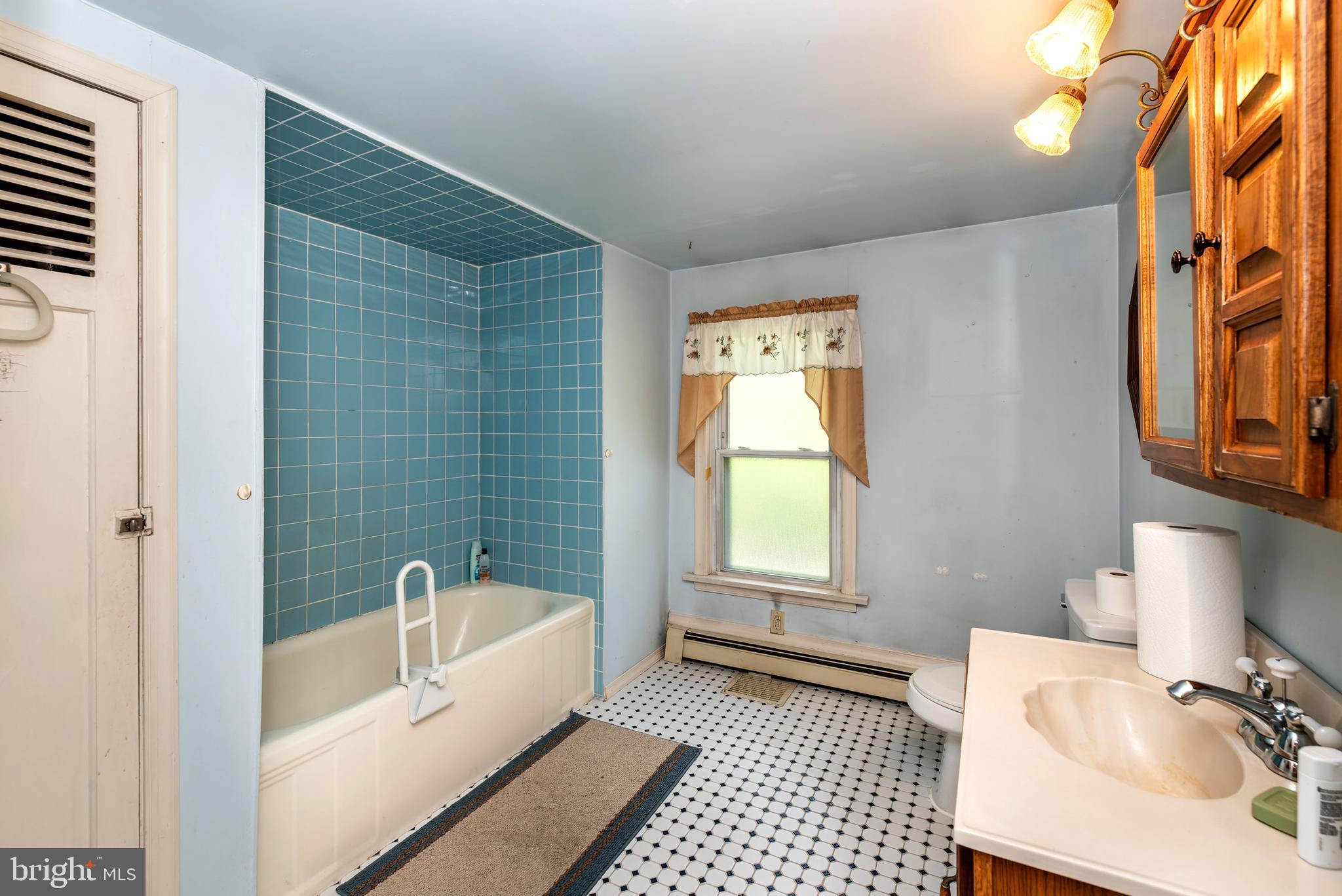 9516 Highland Street Mauricetown, NJ 08329 - Photo 36 of 53 a bathroom with a sink a bathtub and a window