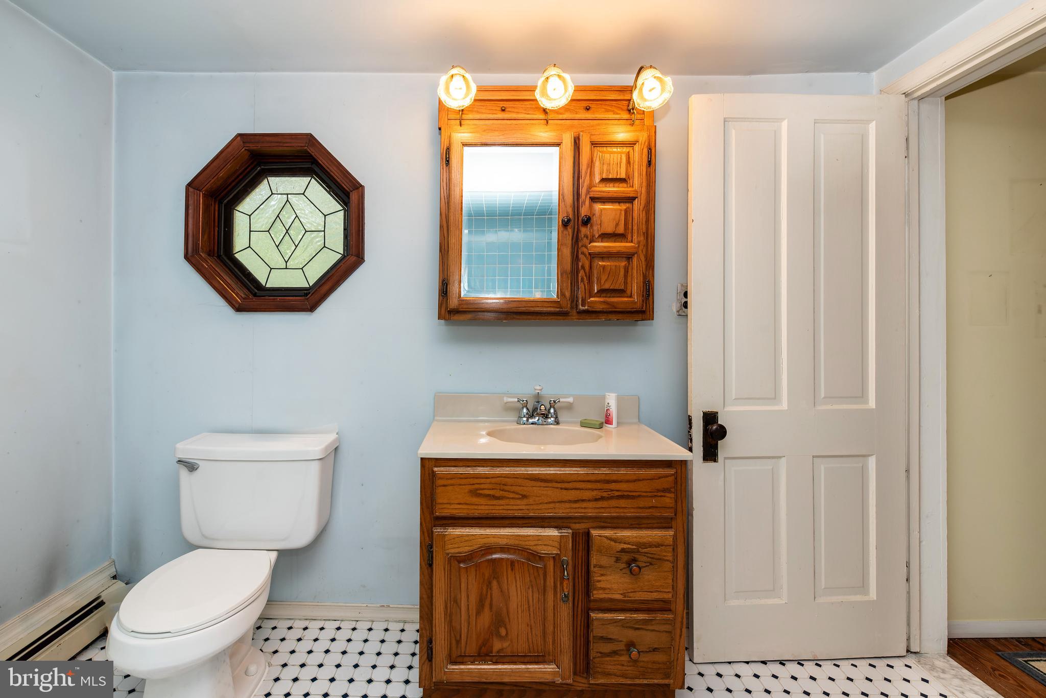 9516 Highland Street Mauricetown, NJ 08329 - Photo 38 of 53 a bathroom with a toilet a sink and a mirror
