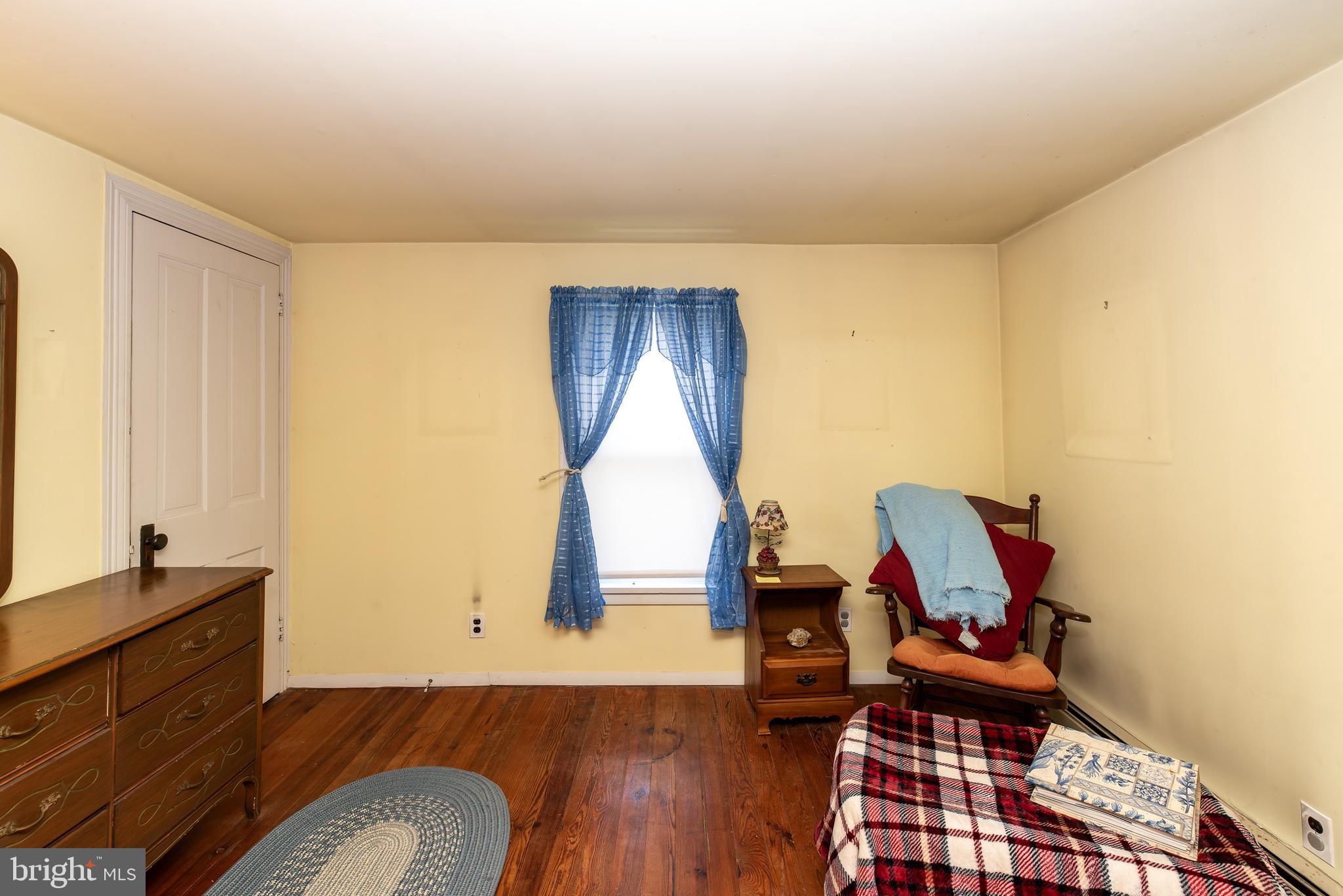 9516 Highland Street Mauricetown, NJ 08329 - Photo 40 of 53 a bedroom with a bed and wooden floor