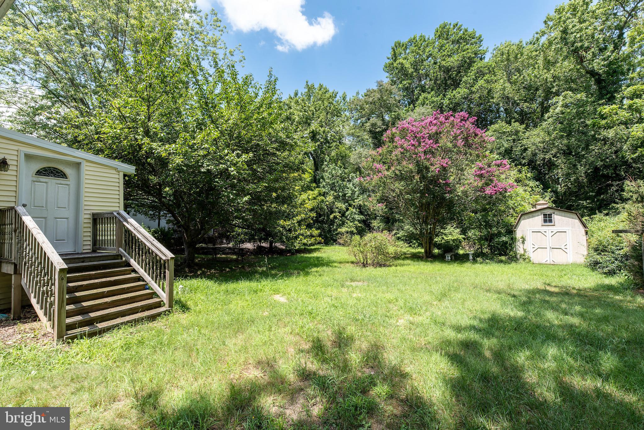 9516 Highland Street Mauricetown, NJ 08329 - Photo 52 of 53 a backyard of a house with lots of green space and fountain