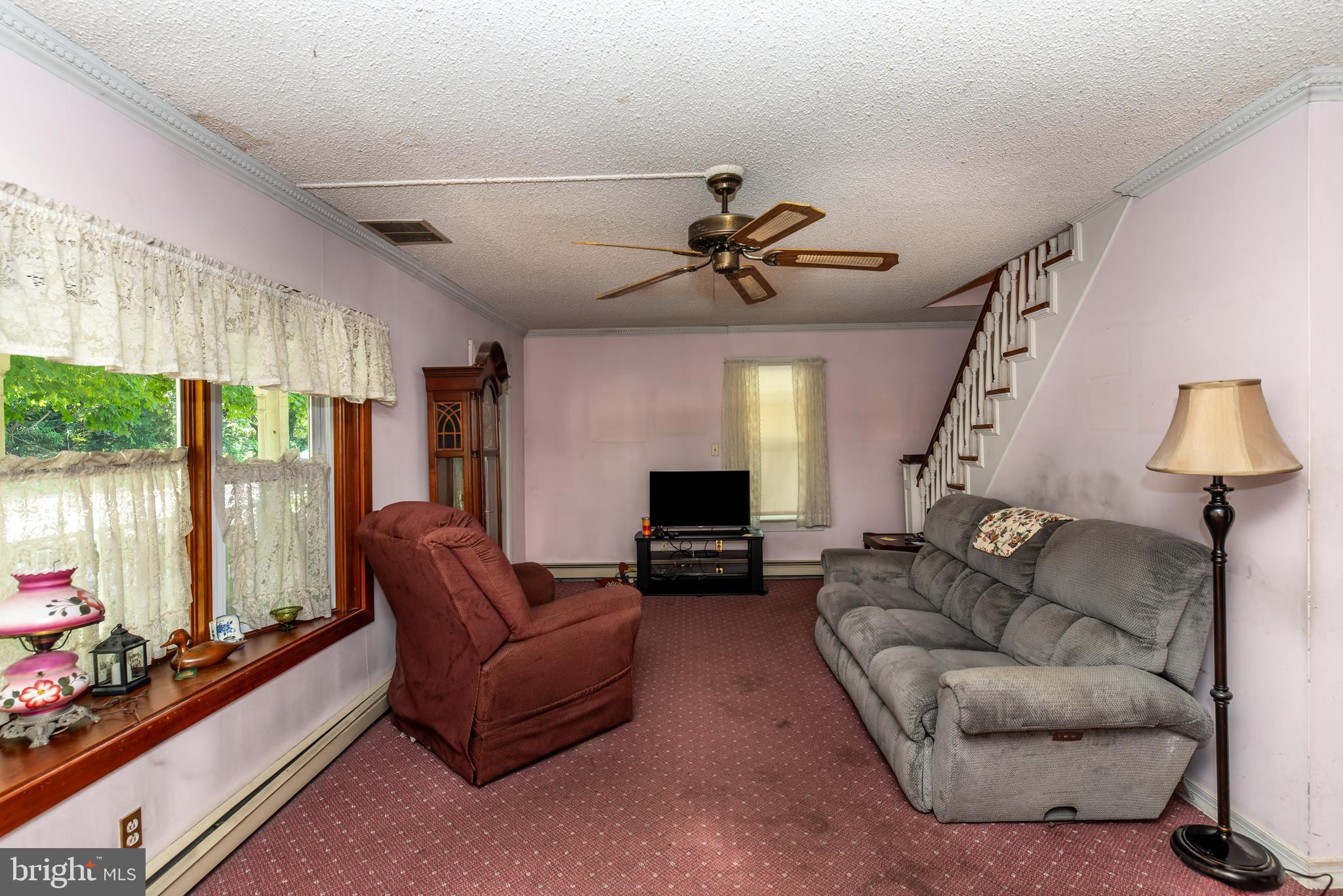 9516 Highland Street Mauricetown, NJ 08329 - Photo 10 of 53 a living room with furniture a flat screen tv and a large window