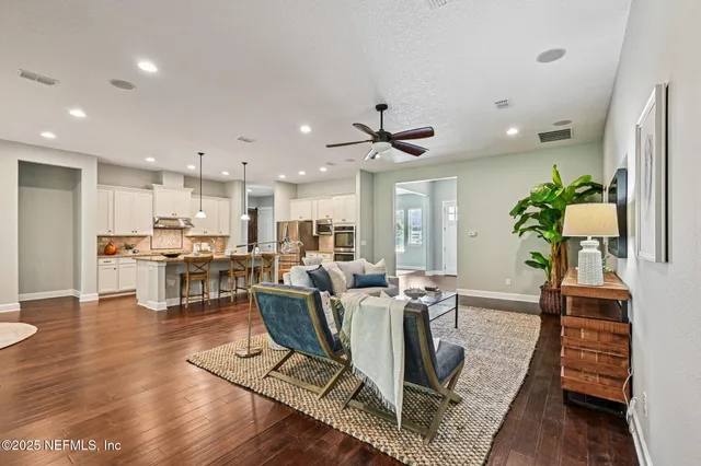 a dining room with furniture a potted plant and a chandelier