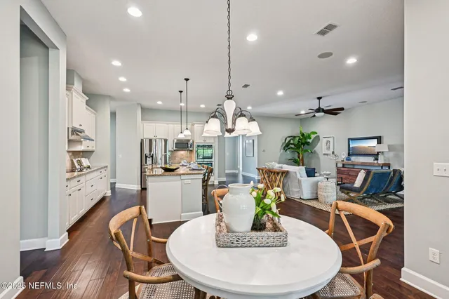 a large kitchen with a table and chairs