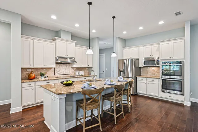 a kitchen with a dining table and chairs