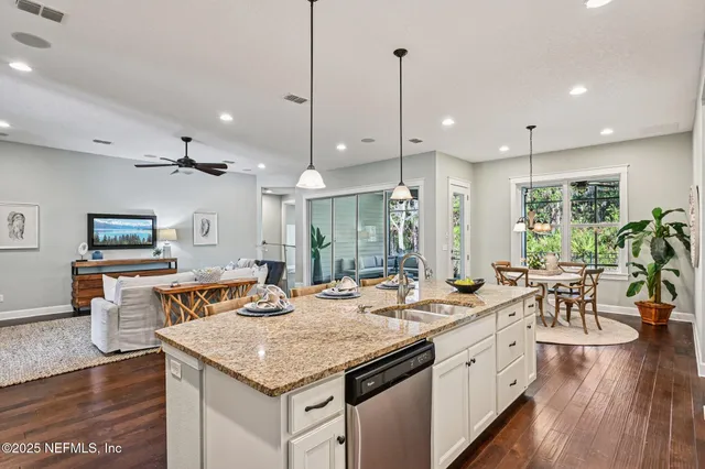 a dining room with furniture a potted plant and a window