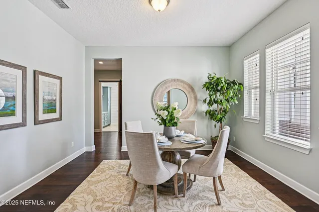 a view of a dining room with furniture and wooden floor