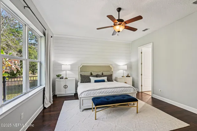 a bathroom with a granite countertop tub shower and mirror