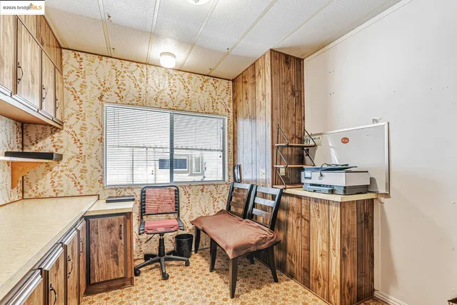 a view of a room with furniture and a window