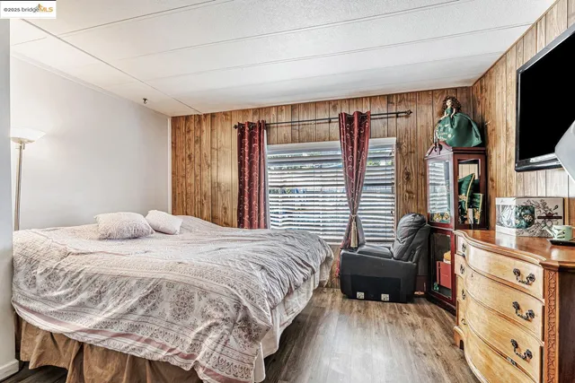 a bedroom with a bed and a mirror