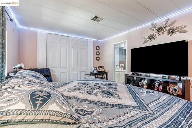 a bedroom with a bed and a couch