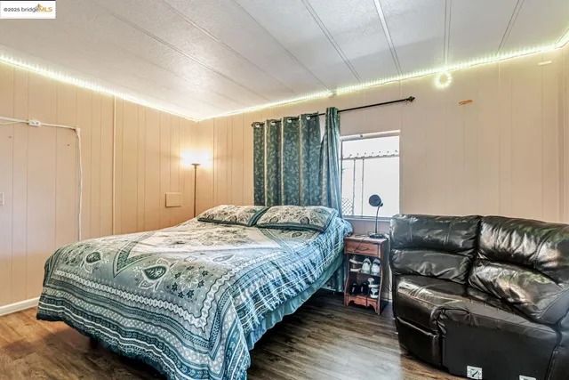 a bathroom with a granite countertop sink a toilet and a mirror