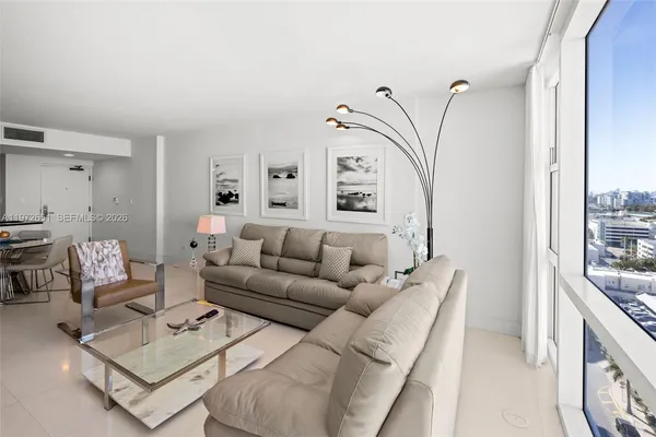 a living room with furniture and a large window