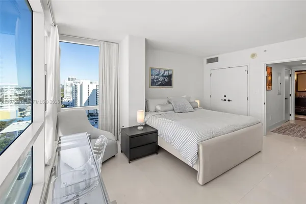 a bedroom with a bed and glass door