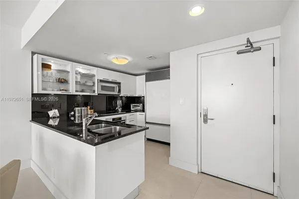 a kitchen with stainless steel appliances granite countertop a refrigerator and a sink