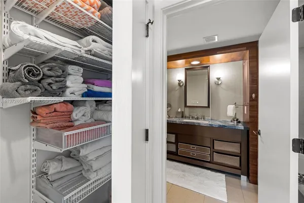 a view of a hallway with glass door and chandelier