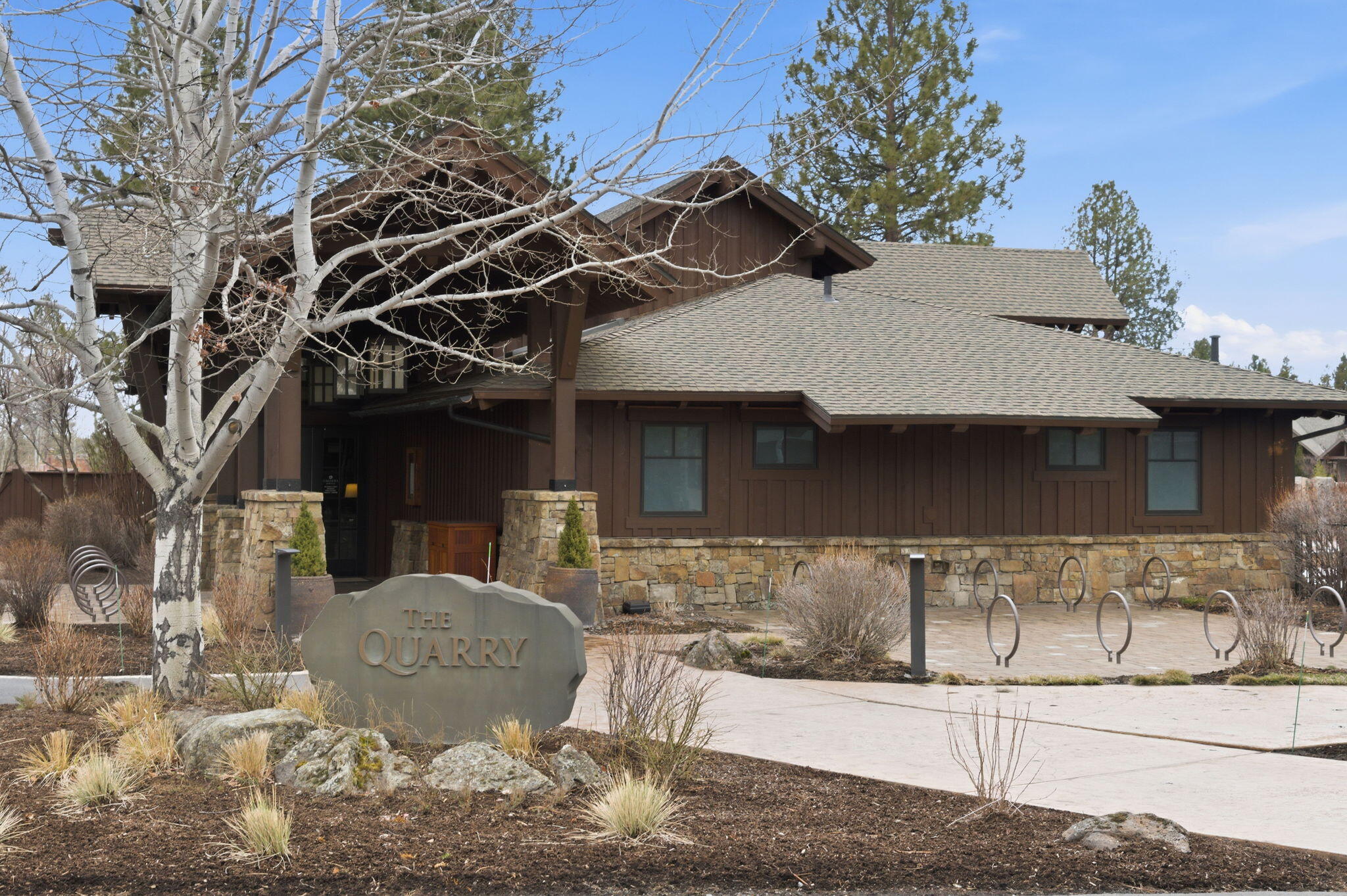 56508 Dancing Rock Loop, Unit 22 Bend, OR 97707 - Photo 60 of 69 a view of a white house with a large tree