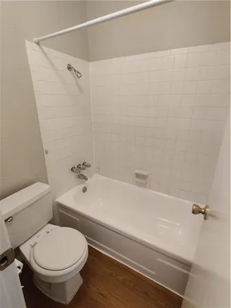 a bathroom with a toilet and a tub