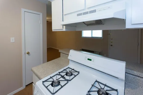 a view of a kitchen cabinets and wooden floor
