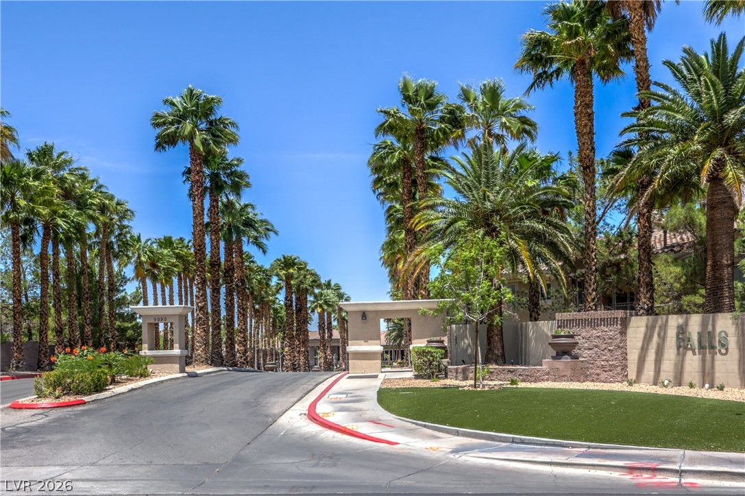 9050 West Warm Springs Road, Unit 2033 Las Vegas, NV 89148 - Photo 29 of 30 Enter through a grand, palm-lined community entrance with mature landscaping.