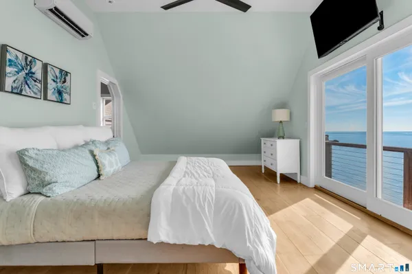 a bed sitting in a bedroom and painting on the wall