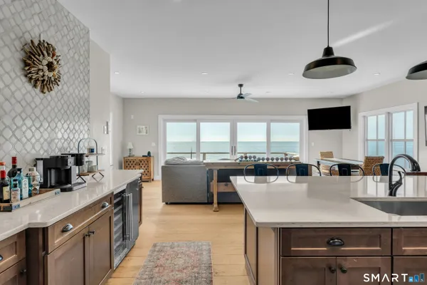 a kitchen with stainless steel appliances granite countertop a sink a stove and a refrigerator