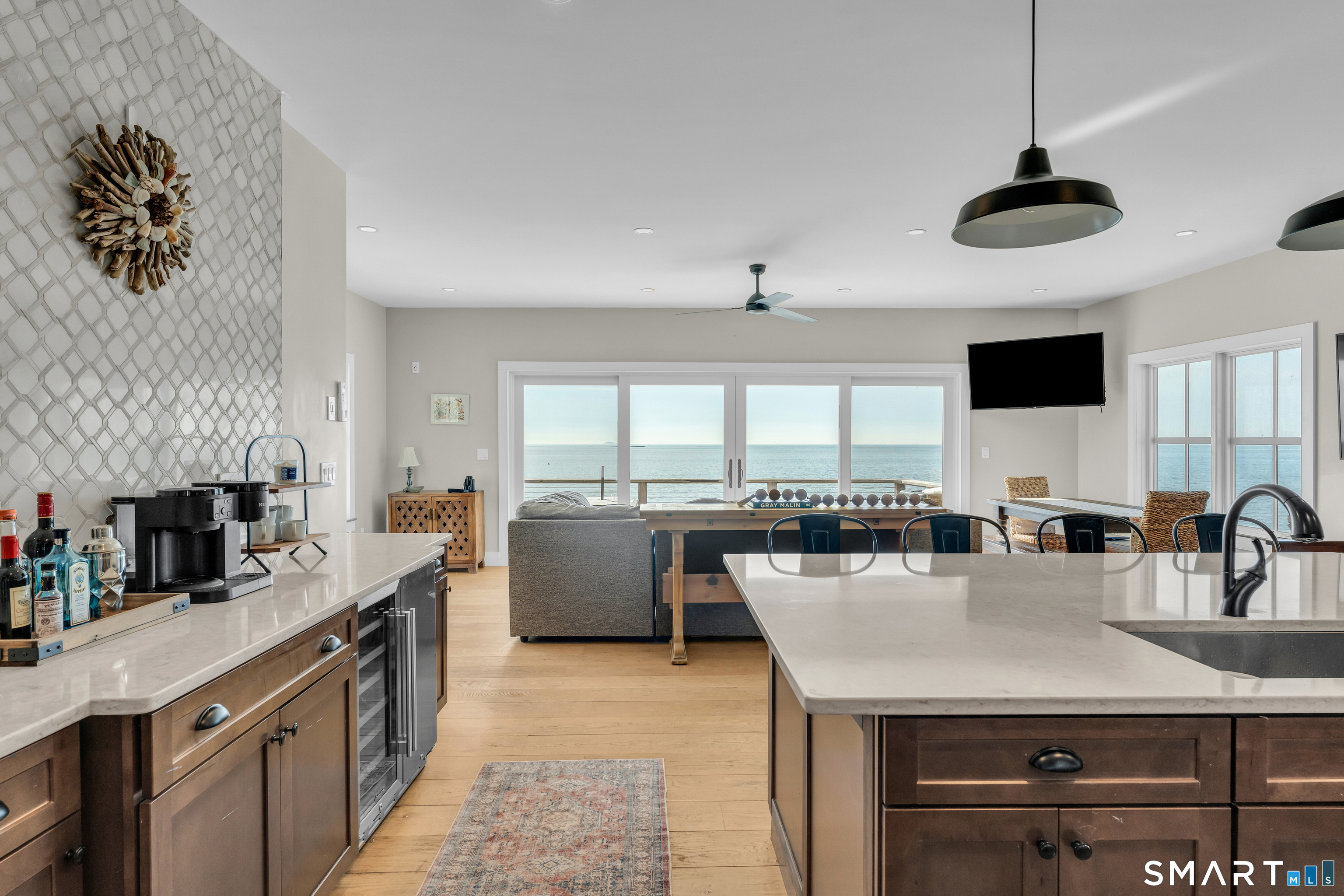 49 Circle Beach Road Madison, CT 06443 - Photo 2 of 20 The fully equipped kitchen opens seamlessly to the main living spaces, perfect for gathering, cooking, and making summer memories.