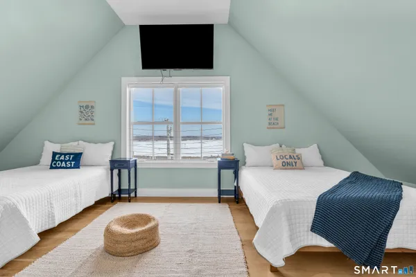 a bedroom with a bed and a flat screen tv