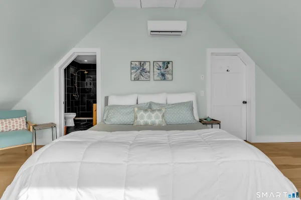 a large bed sitting in a bedroom and lamp