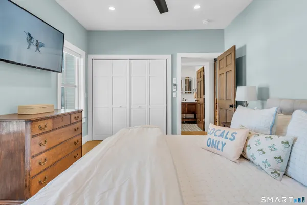 a bedroom with a large bed and furniture