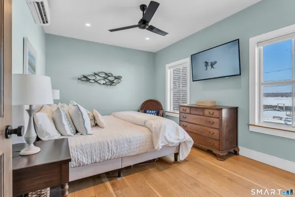a bedroom with a bed and a painting on the wall