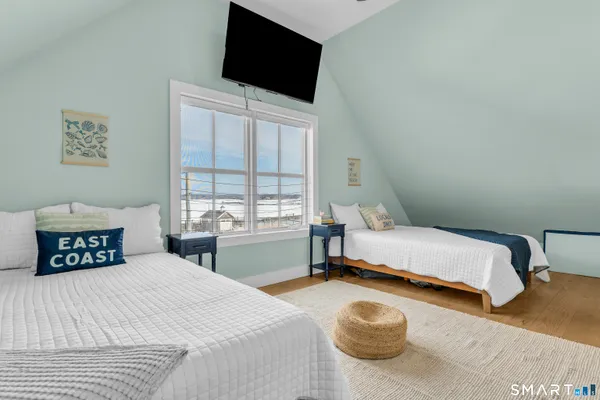 a bedroom with a bed and a flat screen tv