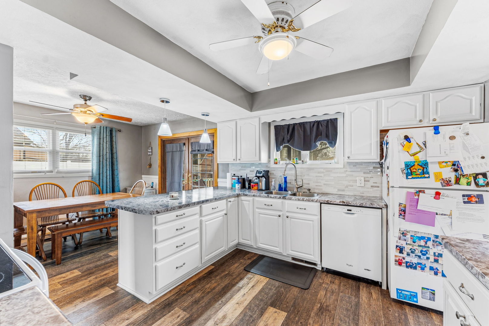 404 Southwest 10th Street Aledo, IL 61231 - Photo 11 of 27 a kitchen with granite countertop cabinets a sink and appliances